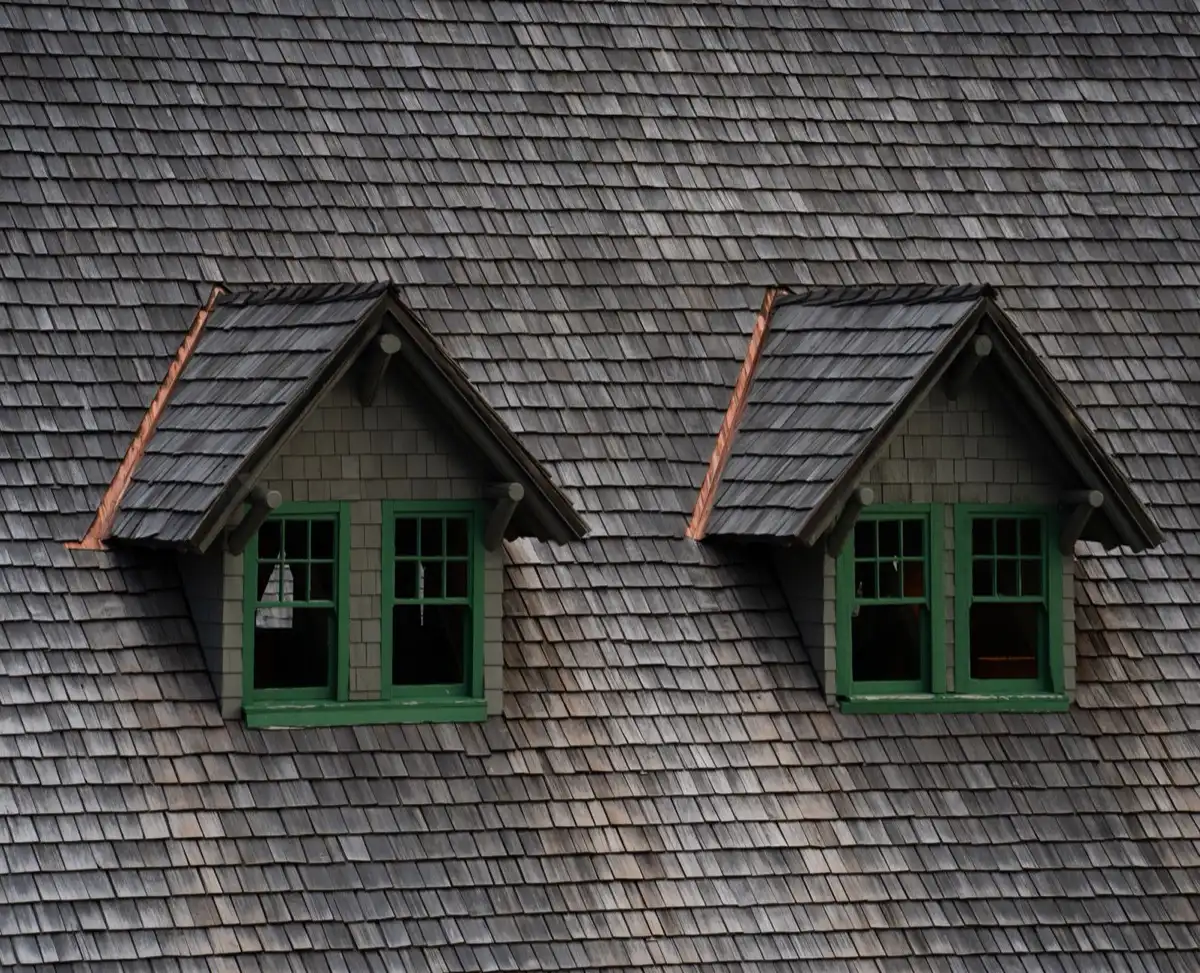 Dormers on a shingle roof in Kissimmee, FL, where step flashing and kickout flashing carry water past the walls